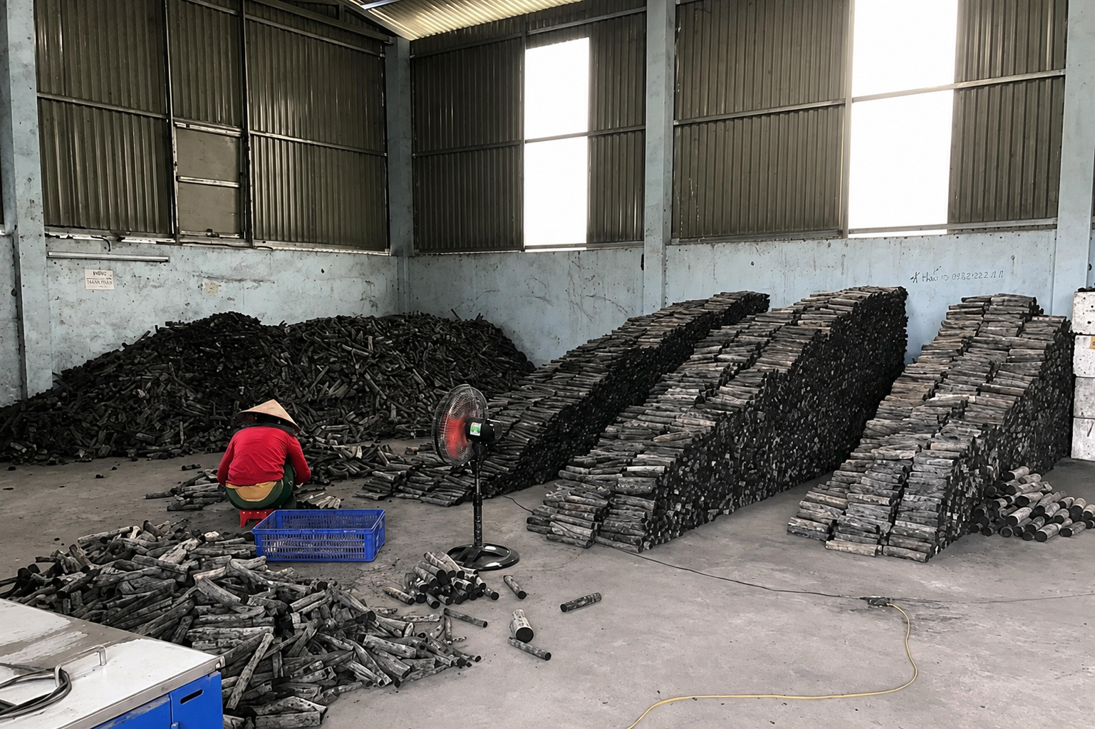 Charcoal sticks sorted and stacked for drying in the workshop